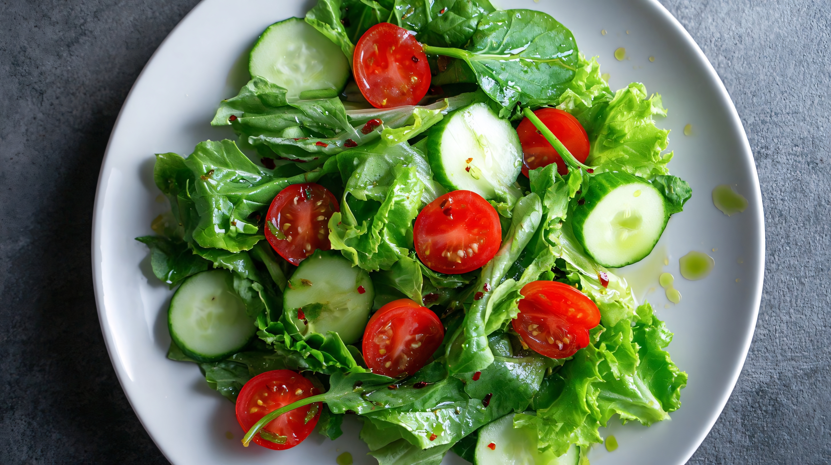 fresh cucumber and tomato salad with leafy greens