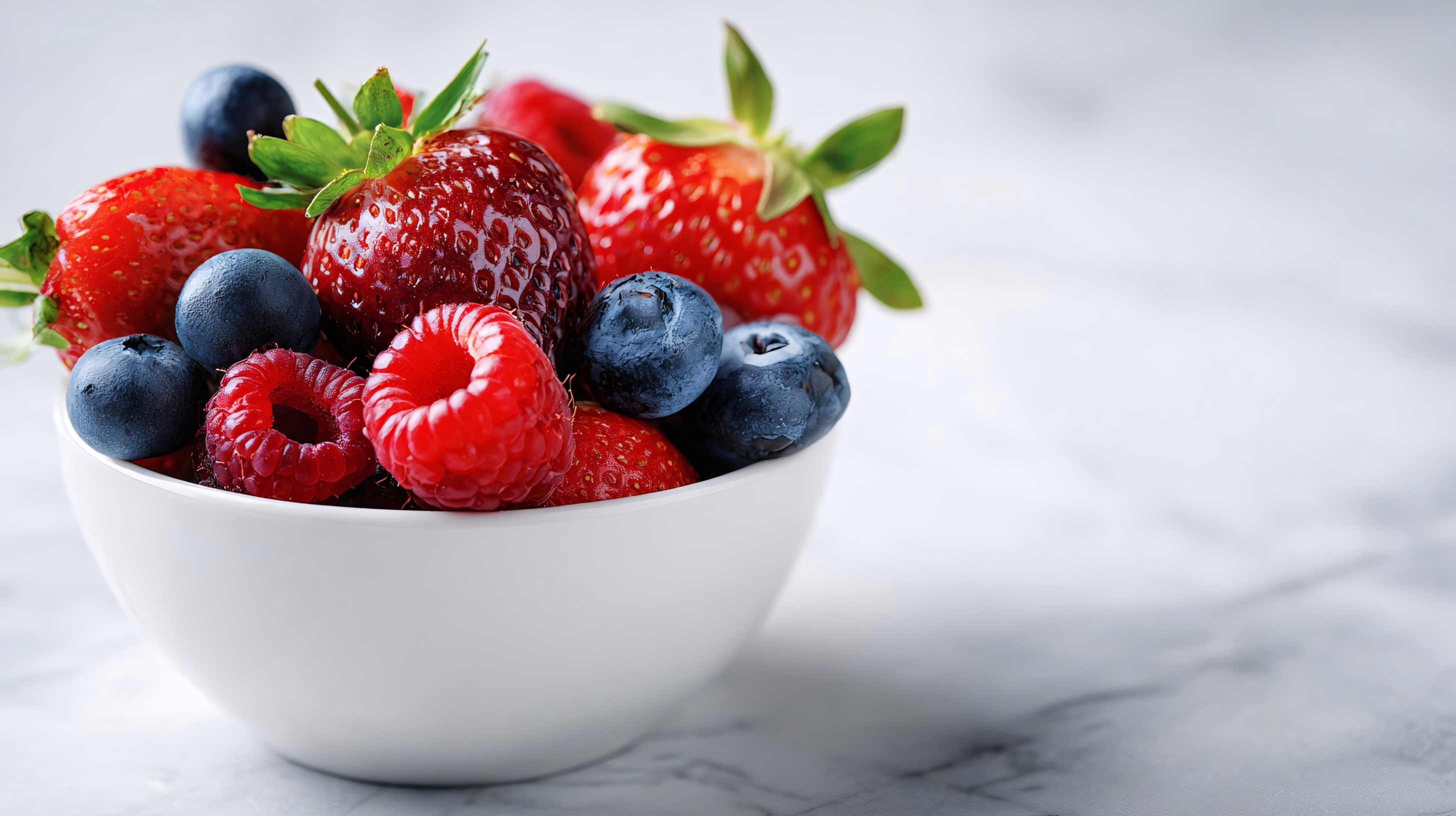 fresh mixed berries in white bowl for healthy fruit snack