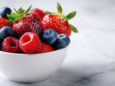 fresh mixed berries in white bowl for healthy fruit snack