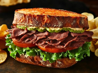 roast beef sandwich with lettuce, tomato, and pickles