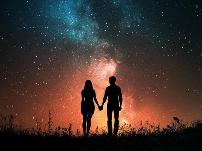 romantic couple holding hands under a starry sky with vibrant sunset background