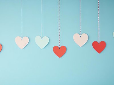 colorful paper hearts hanging on strings for valentine's day background