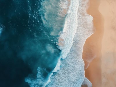 aerial view of ocean waves and sandy beach landscape